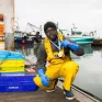 Sedou Koita, meilleur apprenti de France (MAF) Marin pêcheur, dans le port du Havre avec ses médailles